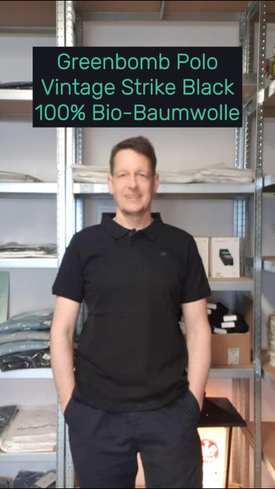 Daniel trägt das nachhaltige Polo Bike Vintage Strike in Schwarz von Greenbomb – aus Bio-Baumwolle, fair produziert und angenehm atmungsaktiv.